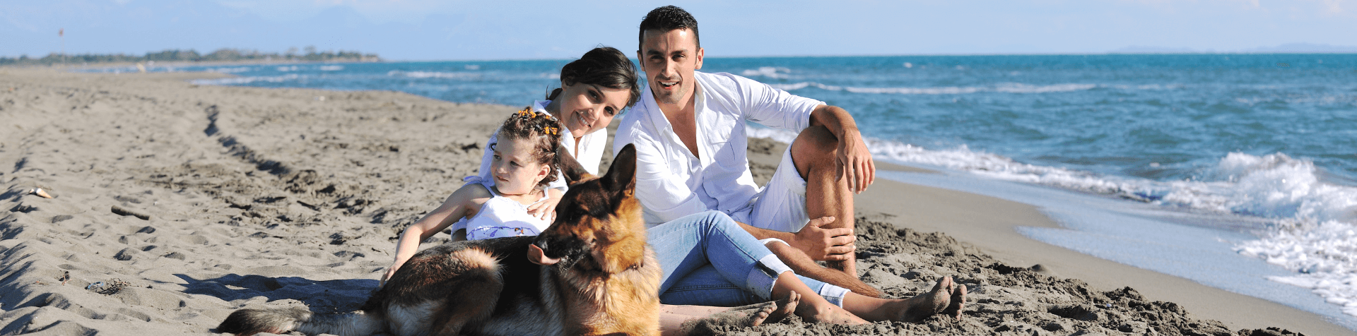 chien allongé sur la plage en famille